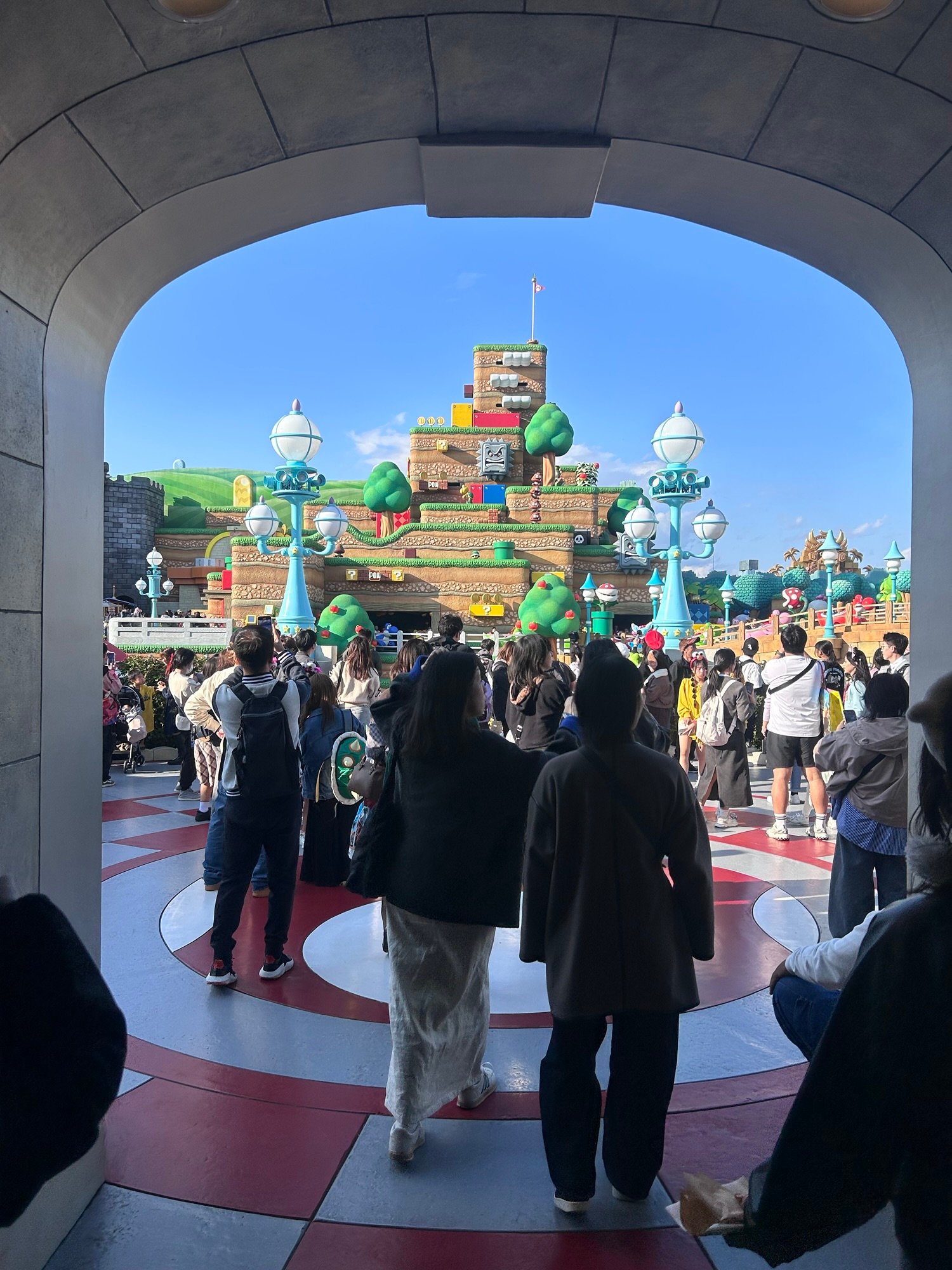 Super Nintendo World at Universal Studios Japan entrance with visitors walking inside Osaka theme park.