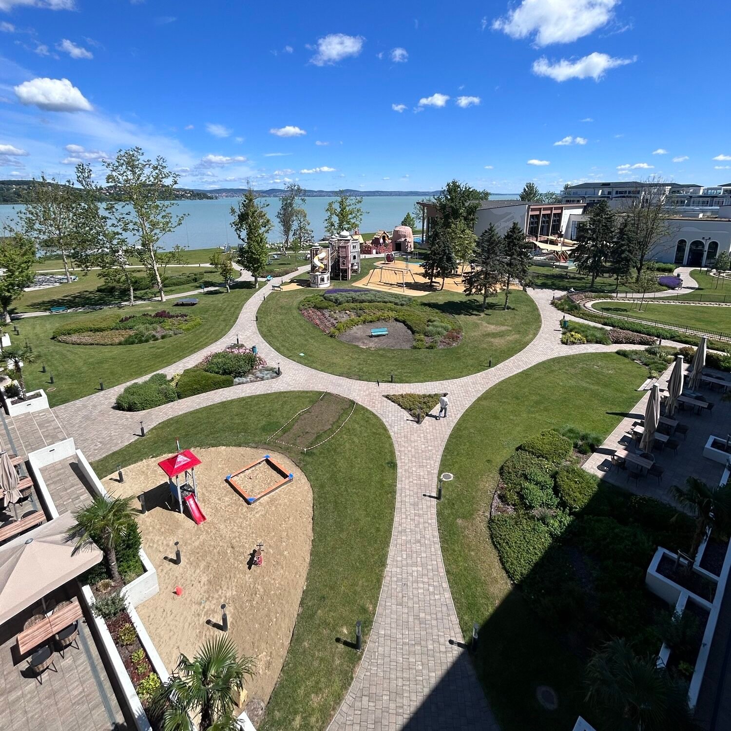 Aerial view of Mövenpick BalaLand Resort overlooking Lake Balaton un Hungary with family playgrounds and gardens.