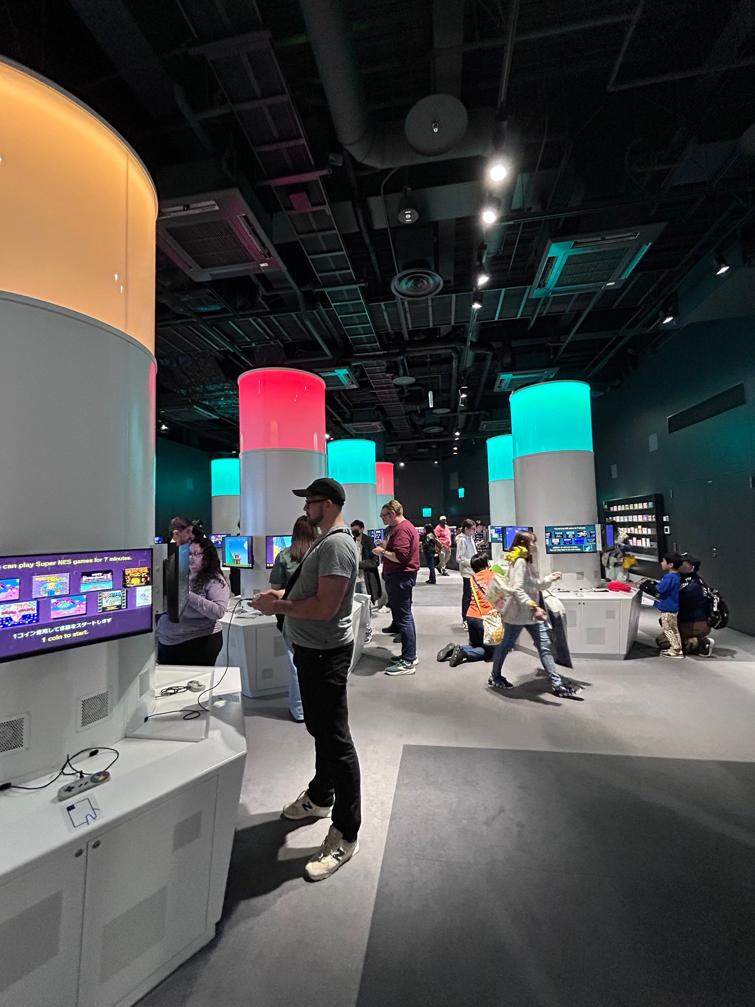 Visitors playing classic Nintendo consoles at the Nintendo Museum Kyoto.
