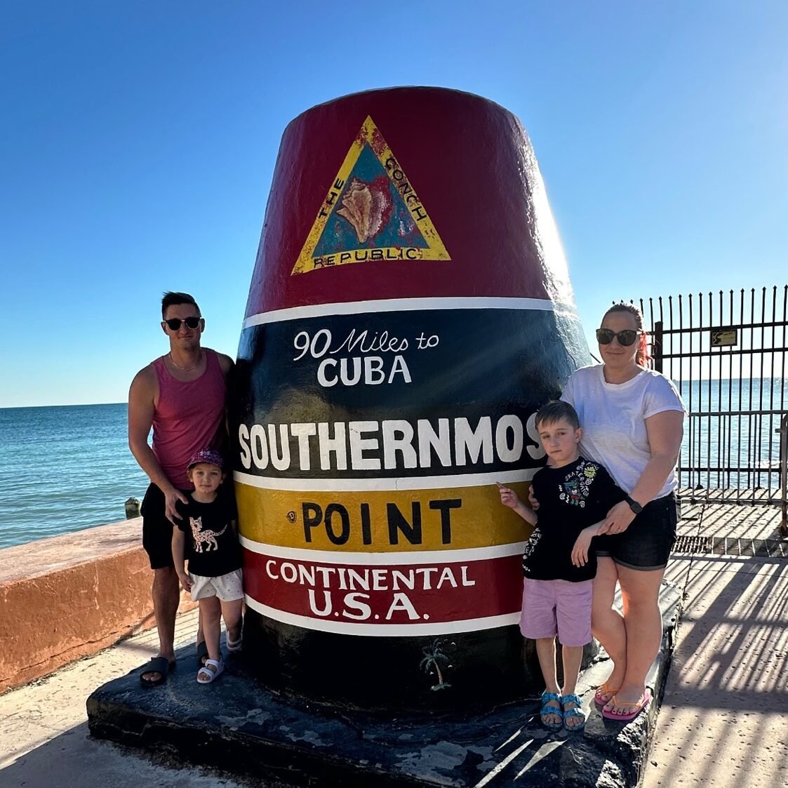 Family visiting Southernmost Point in Key West with kids