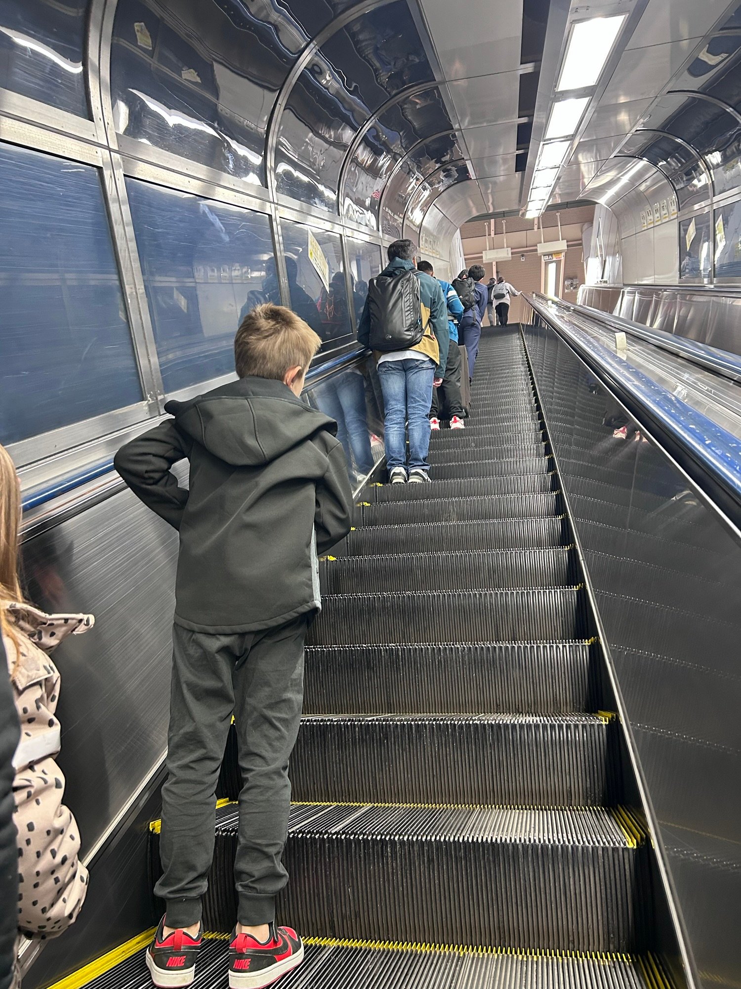 Long escalator at Tokyo Station while travelling with kids