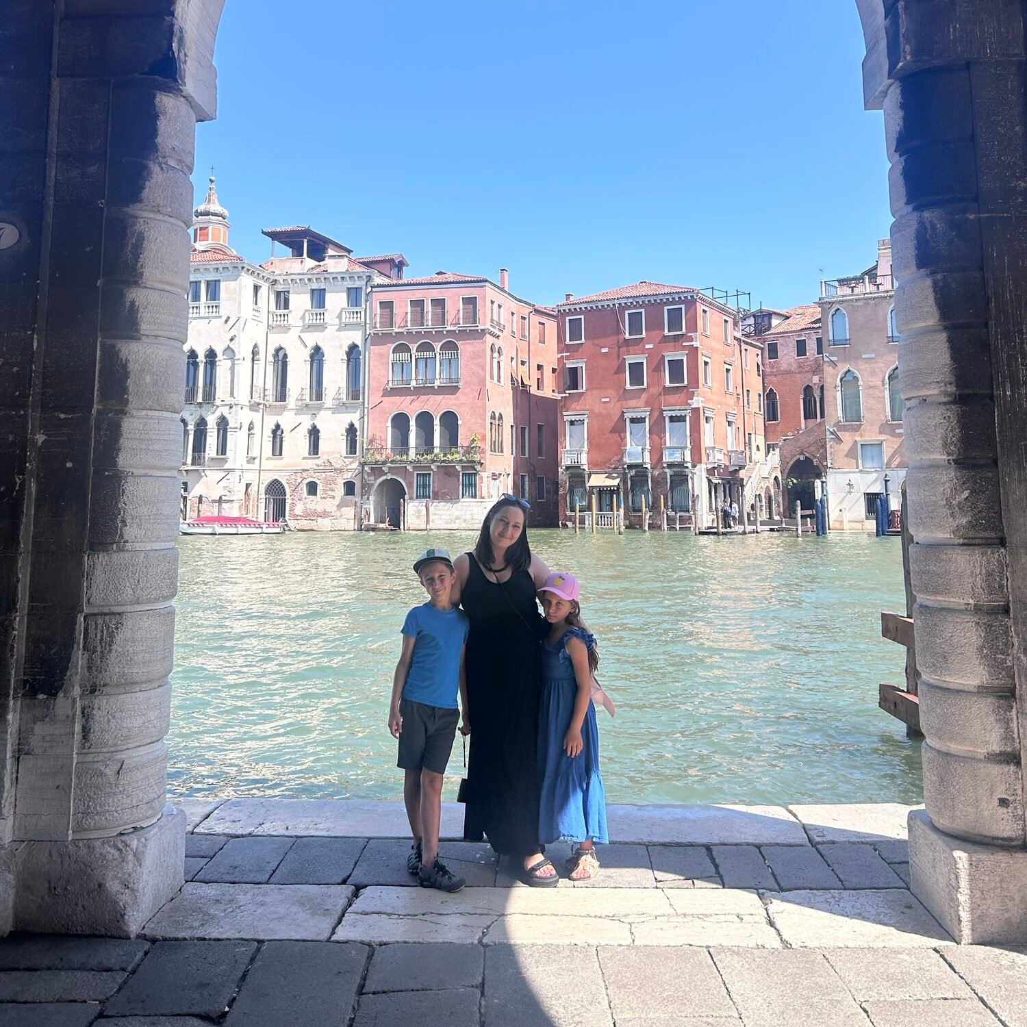 Family exploring Venice with kids beside the Grand Canal
