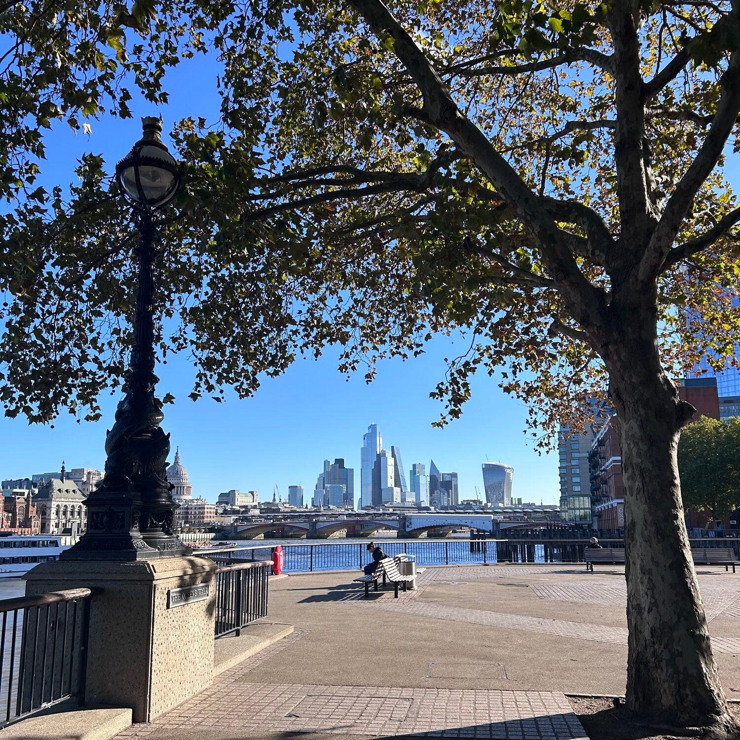 London tourist mistakes guide featuring a riverside walk along the Thames with the London skyline