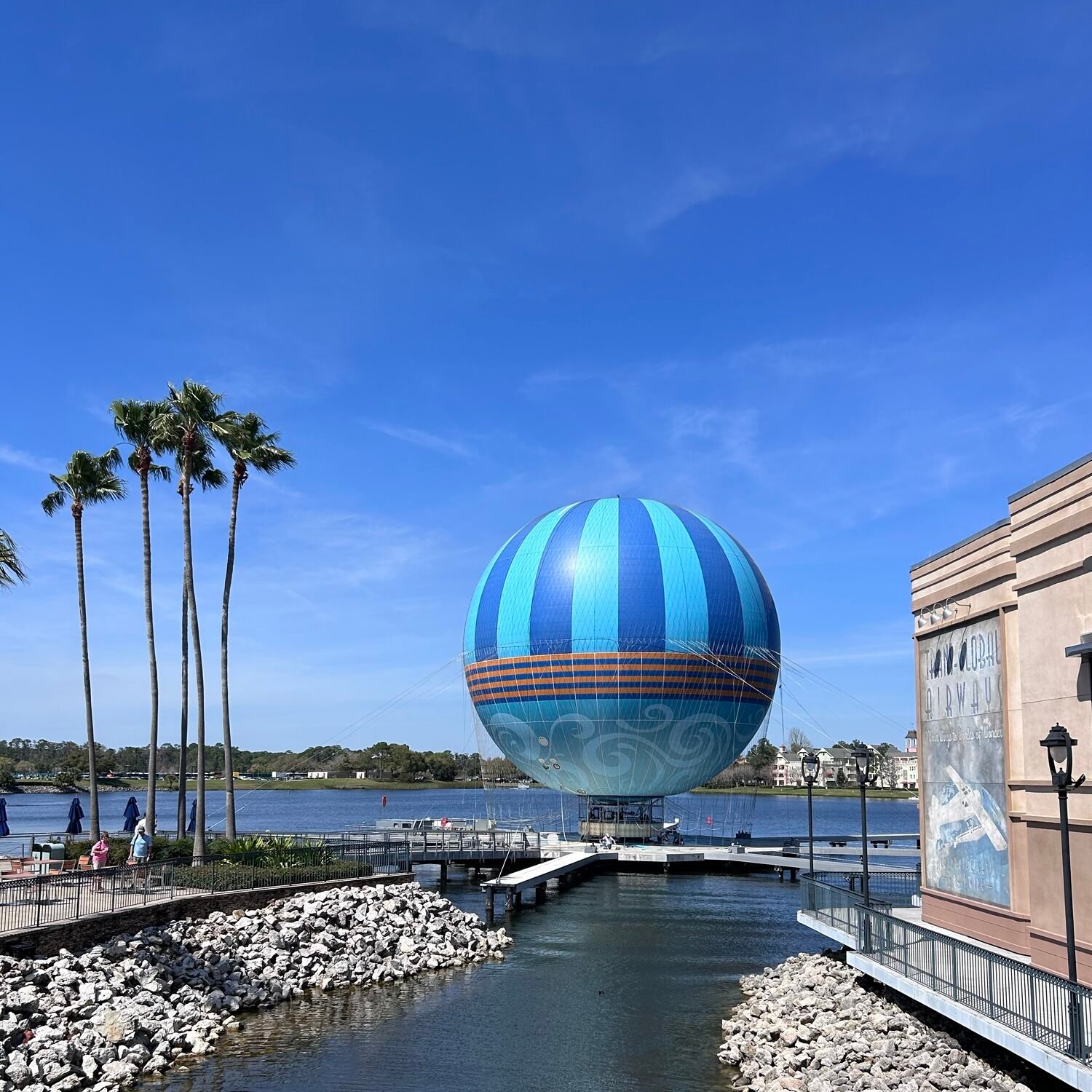 Disney Springs with kids overlooking the lake and Aerophile balloon