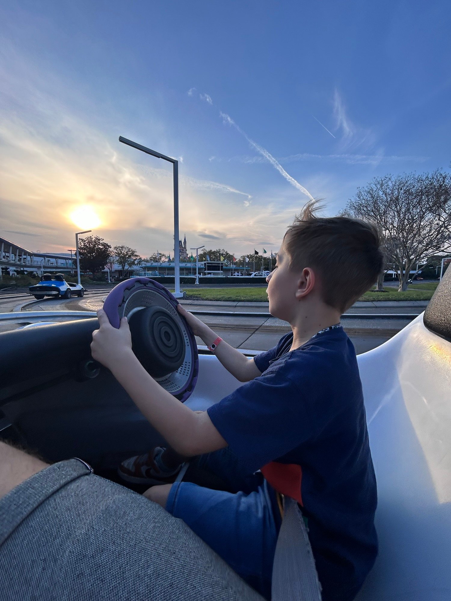 Child steering a race car on Tomorrowland Speedway at Magic Kingdom