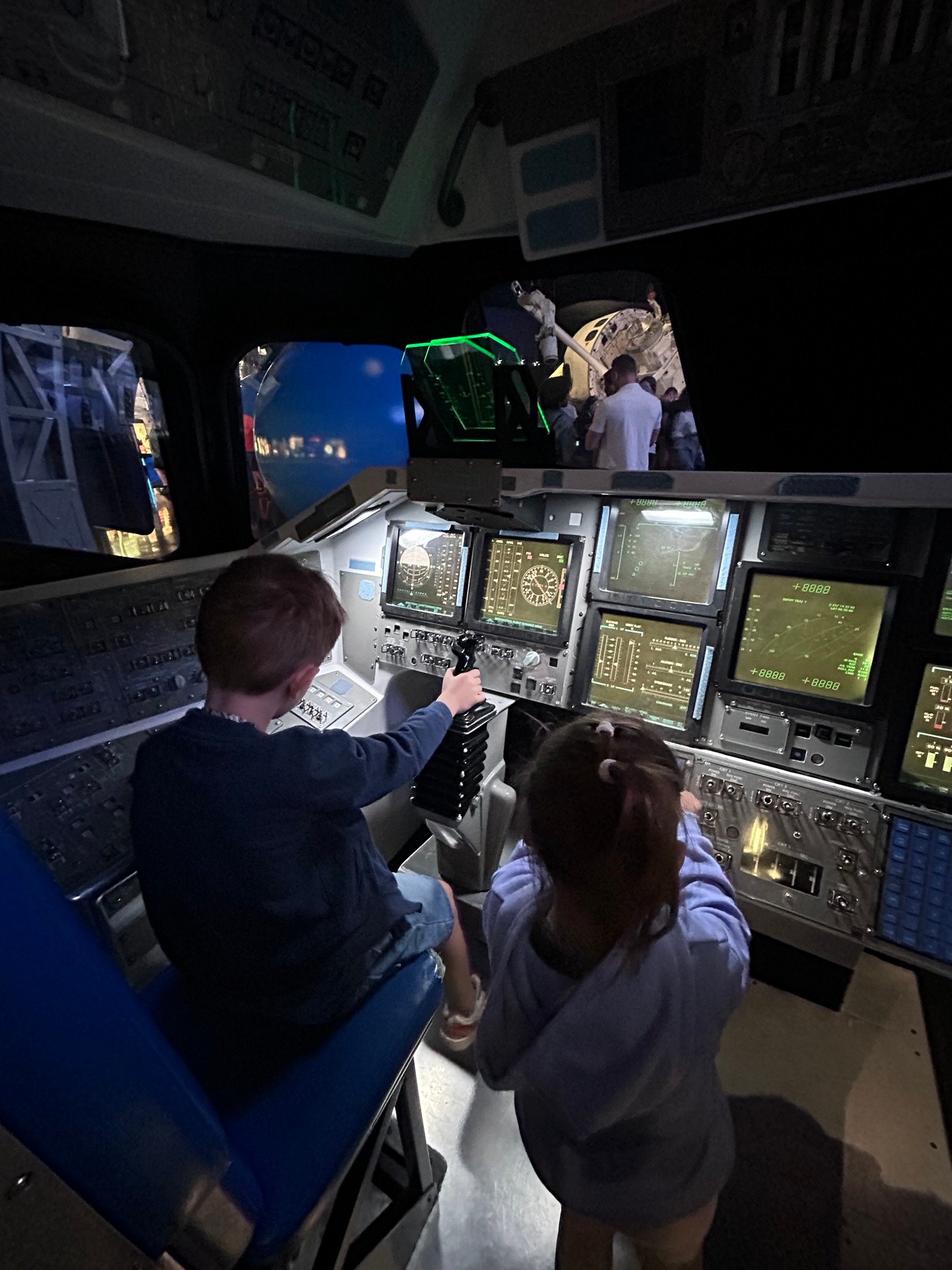 Kids using interactive exhibits at Kennedy Space Center
